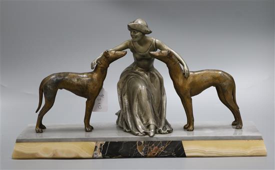 An Art Deco model of a girl with two dogs on a marble base